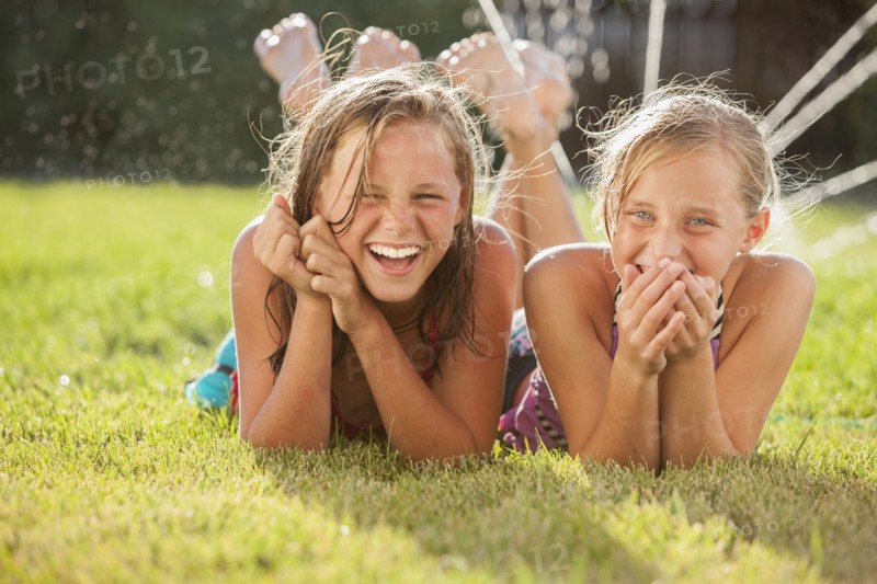 Caucasian girls laying in the grass