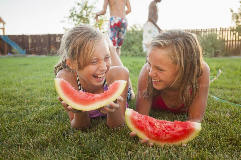 Caucasian girls eating watermelon