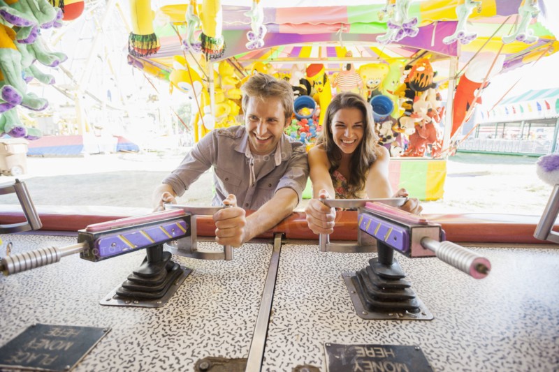 Caucasian couple playing games at carnival