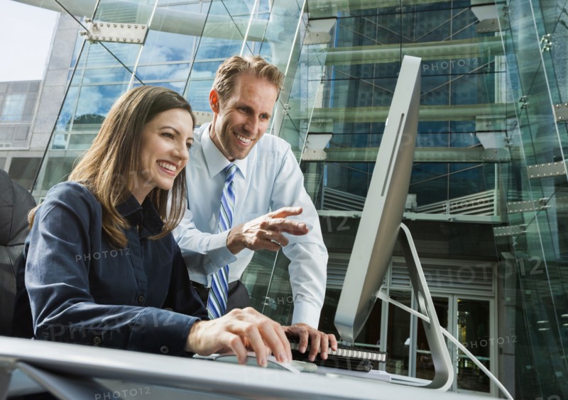 Caucasian business people working at computer