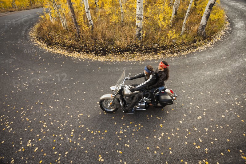 Caucasian couple riding motorcycle