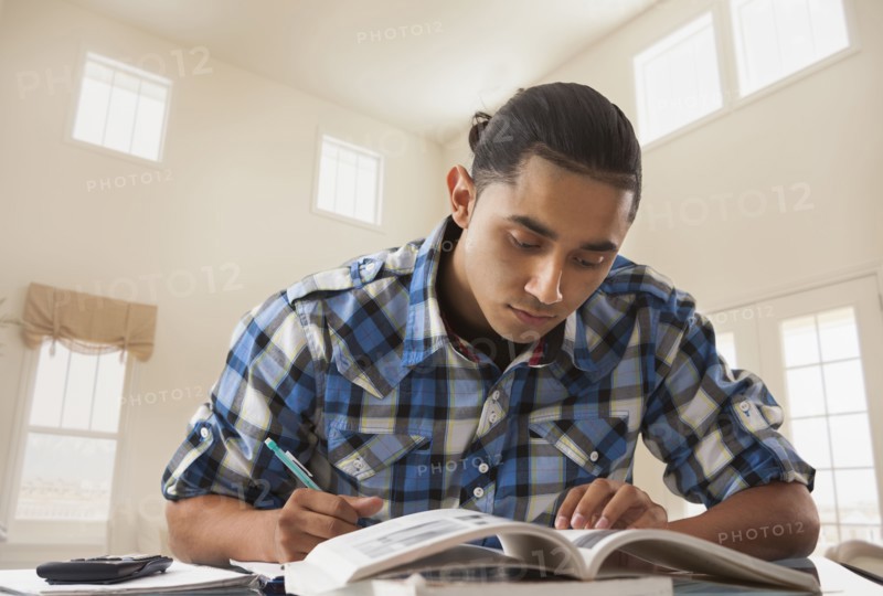 Hispanic man studying at desk