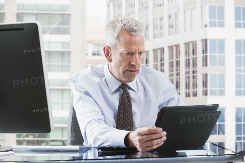 Caucasian businessman using tablet computer