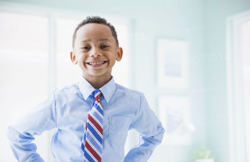 Mixed race boy wearing shirt and tie