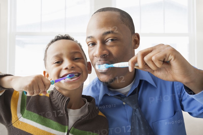 Father and son brushing their teeth