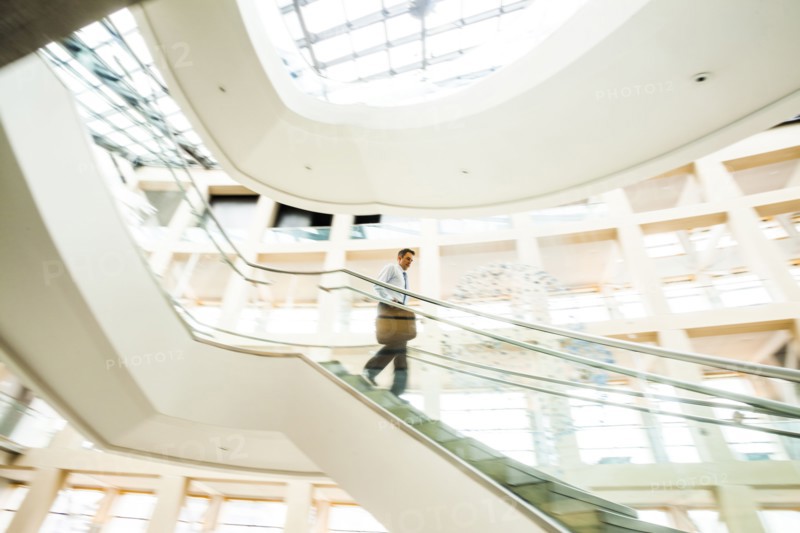 Caucasian businessman rushing on office staircase
