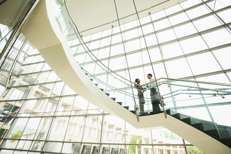 Business people talking on office staircase