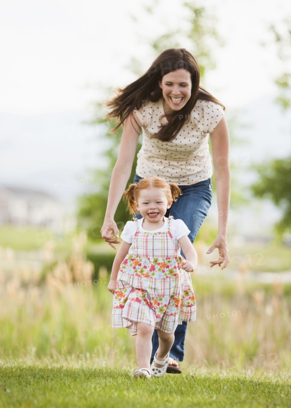 Caucasian mother and daughter playing outdoors
