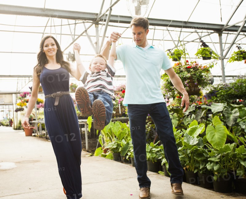 Caucasian family shopping in plant nursery