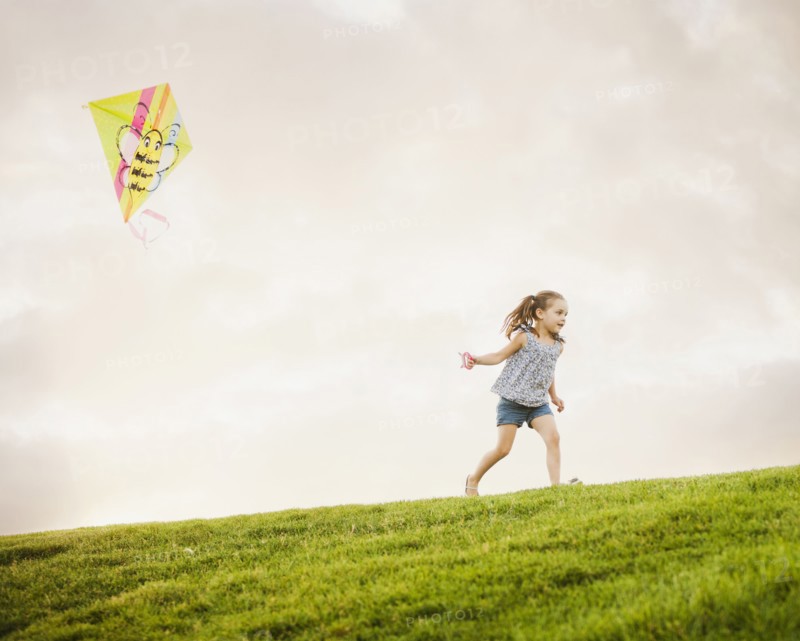 Caucasian girl flying kite