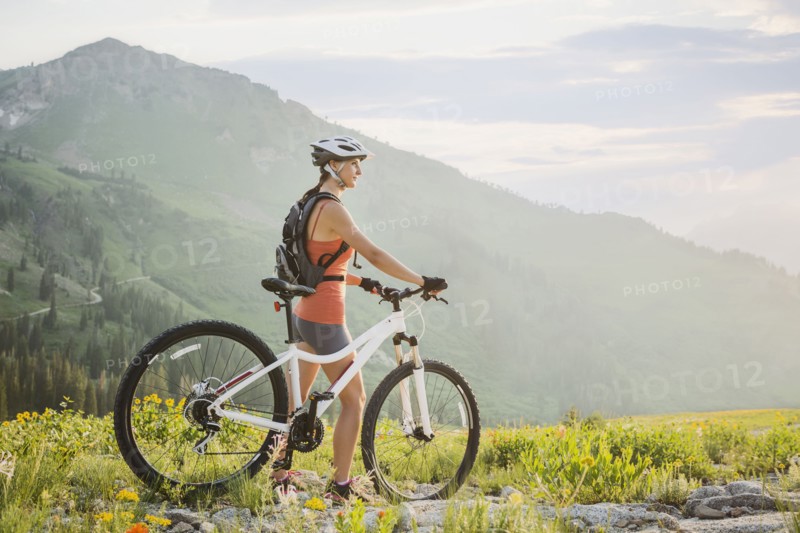 Caucasian woman with mountain bike looking at view