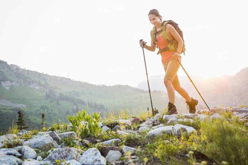 Caucasian woman hiking on rocky trail