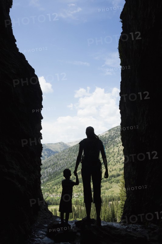 Caucasian mother and son exploring cave