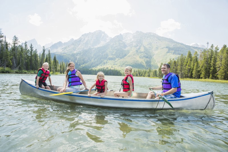 Caucasian family in canoe on lake