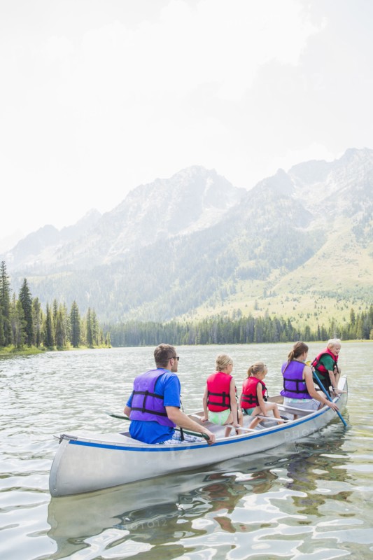Caucasian family in canoe on lake