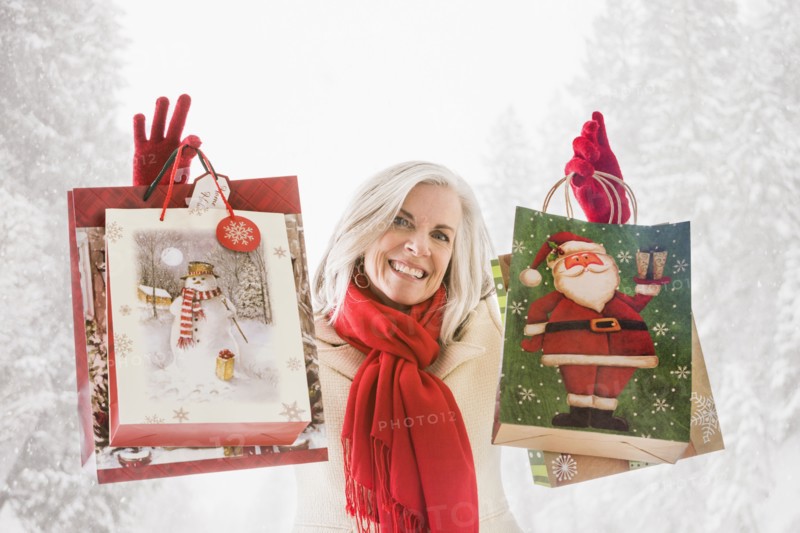 Smiling Caucasian woman with Christmas bags