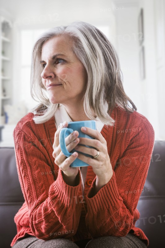Pensive Caucasian woman drinking coffee
