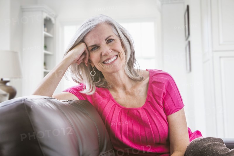 Portrait of smiling Caucasian woman on sofa