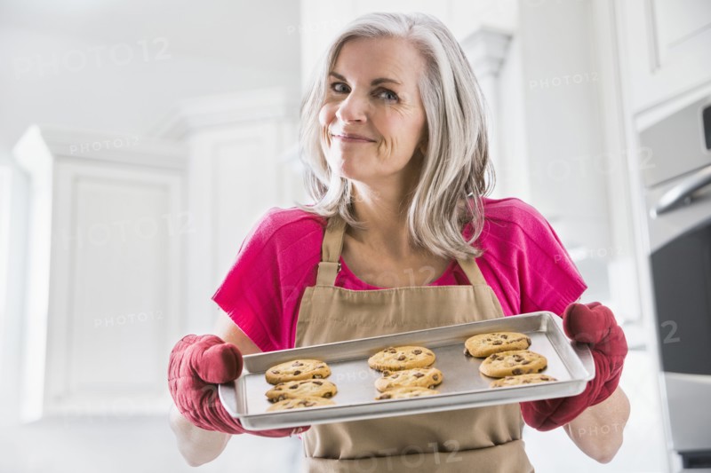 Portrait of Caucasian woman holding baked cookies