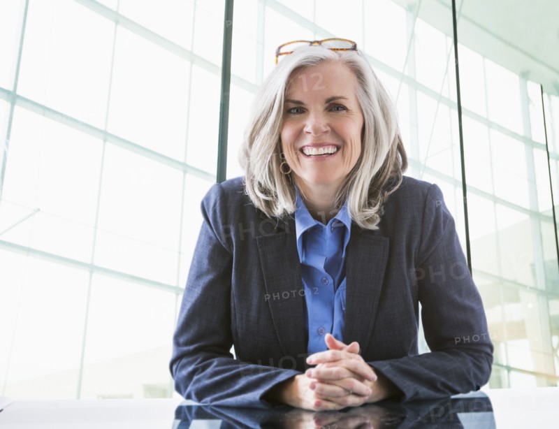 Portrait of confident Caucasian businesswoman at desk