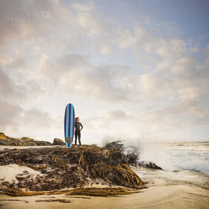 Caucasian surfer with board on beach