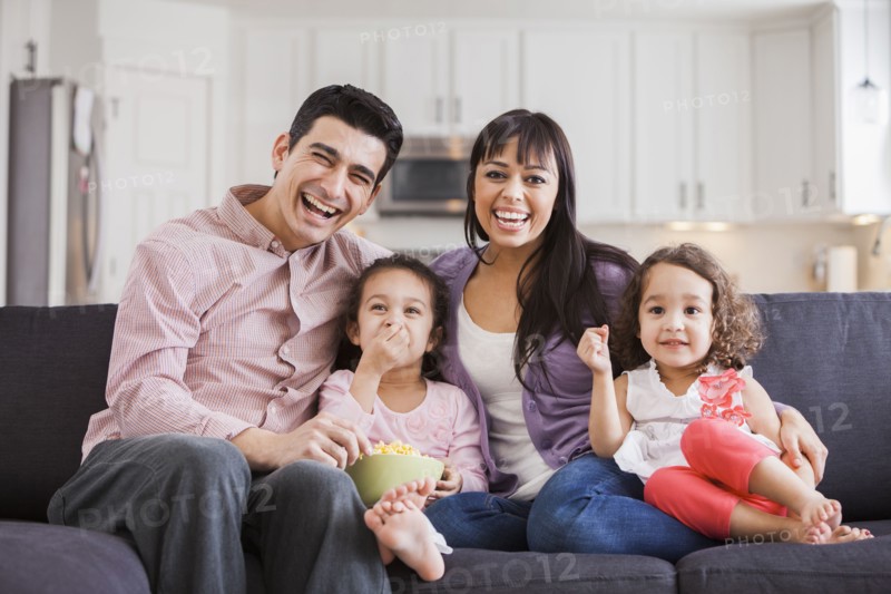 Family smiling together on sofa