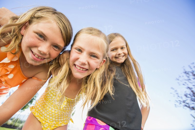 Low angle view of Caucasian girls smiling outdoors