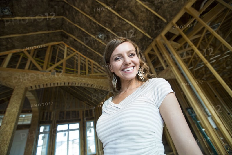 Caucasian woman smiling in house under construction