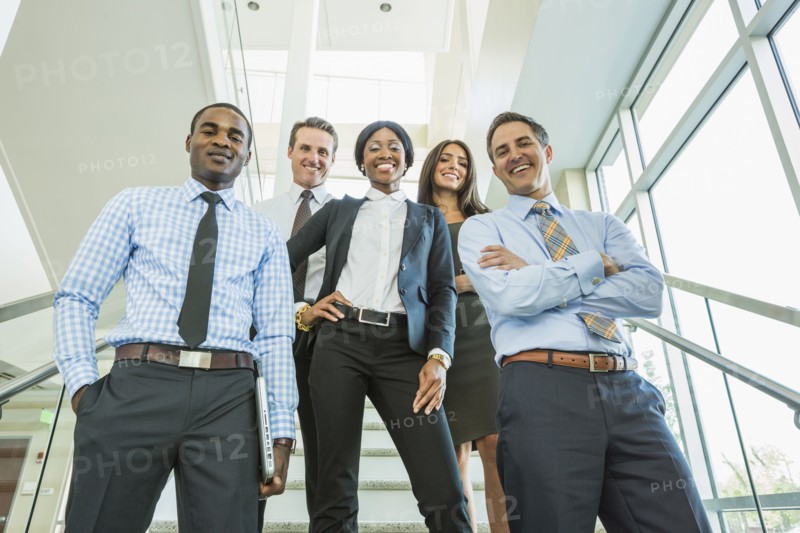 Low angle view of business people smiling on office staircase