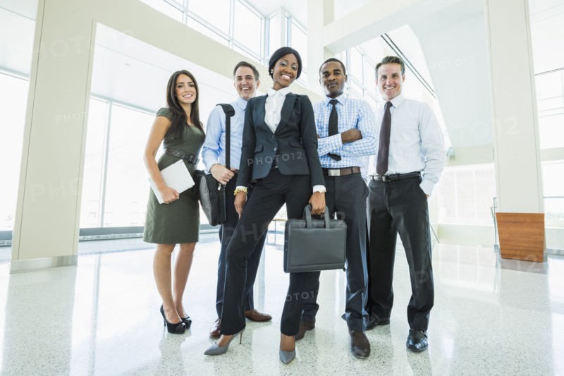 Business people smiling in office lobby