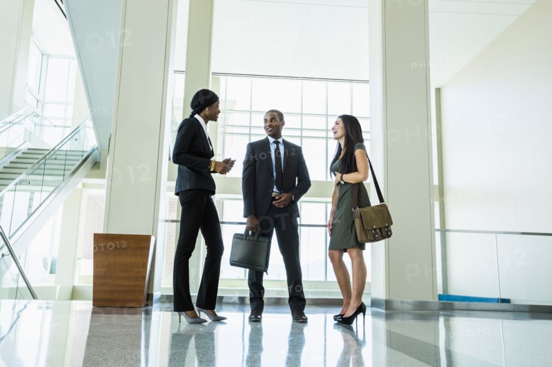 Business people talking in office hallway