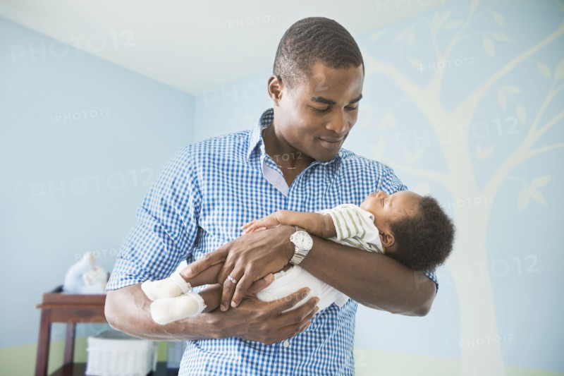 Father cradling baby son