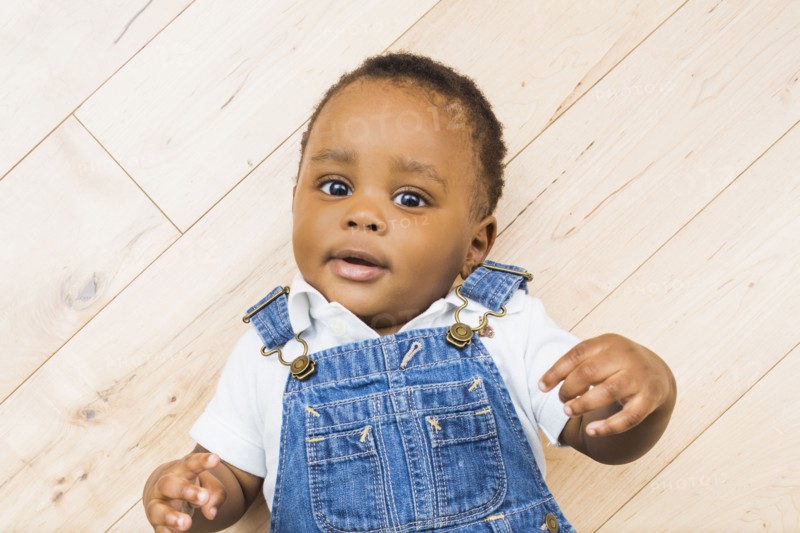 Black baby boy laying on floor