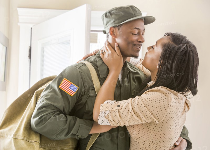 Close up of woman kissing returning soldier