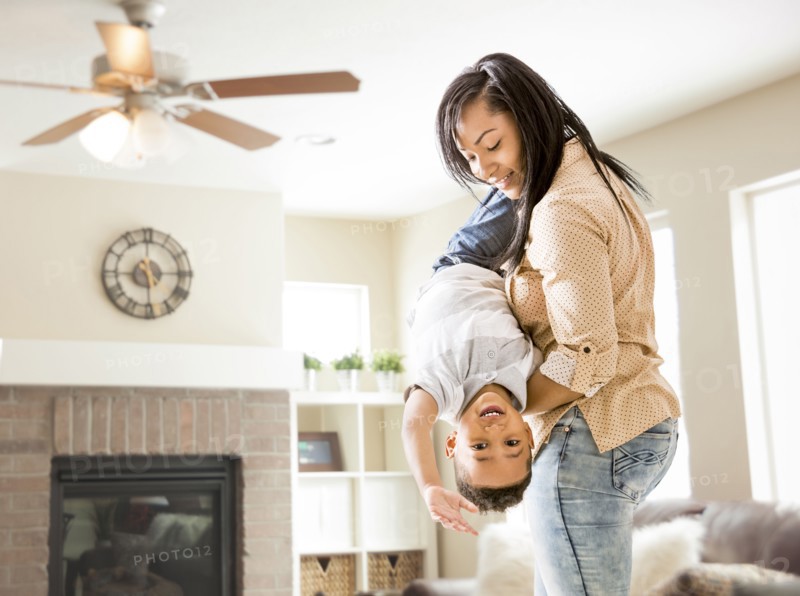 Mixed race mother and son playing in living room