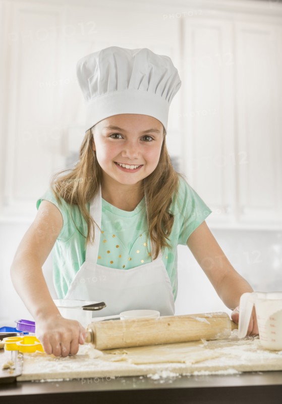 Caucasian girl baking in kitchen