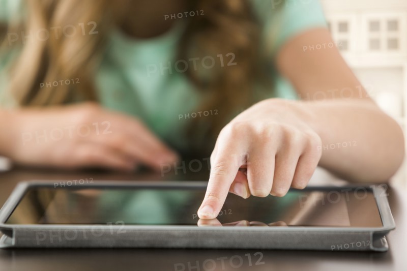 Close up of Caucasian girl using digital tablet