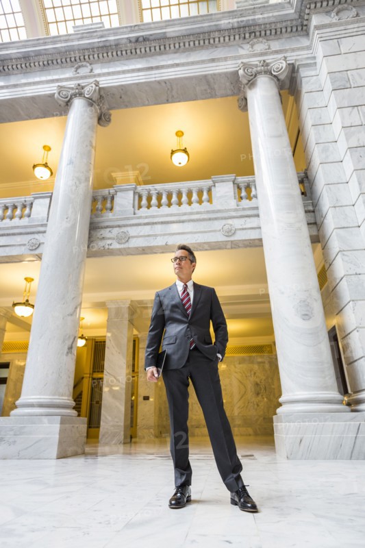 Mixed race businessman standing in courthouse