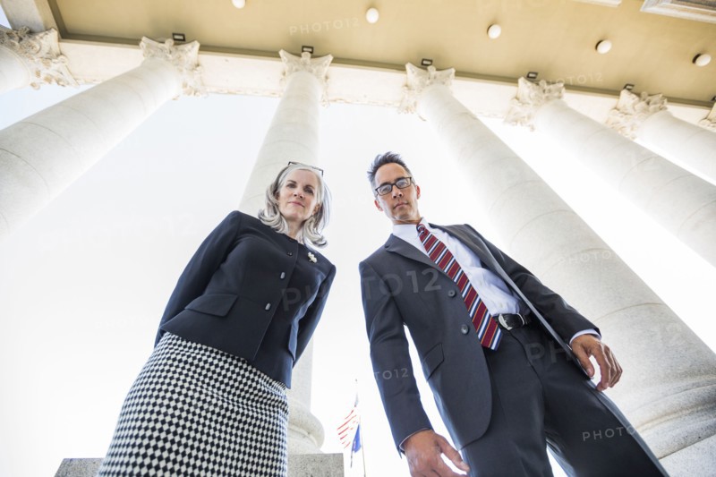 Low angle view of business people under columns