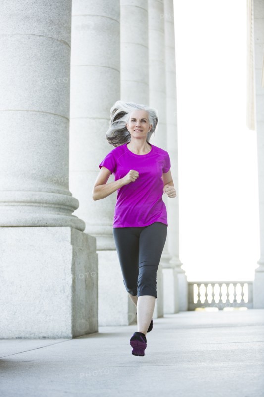 Caucasian woman jogging outside courthouse