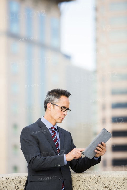 Mixed race businessman using digital tablet