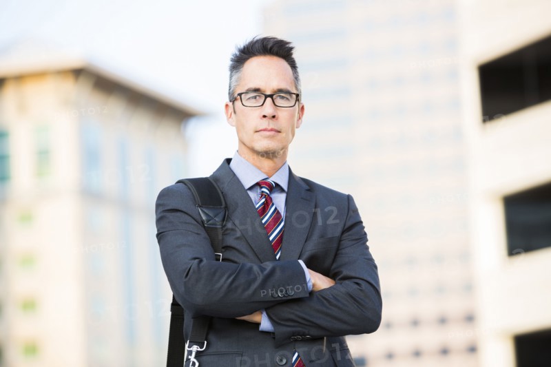 Mixed race businessman standing outdoors