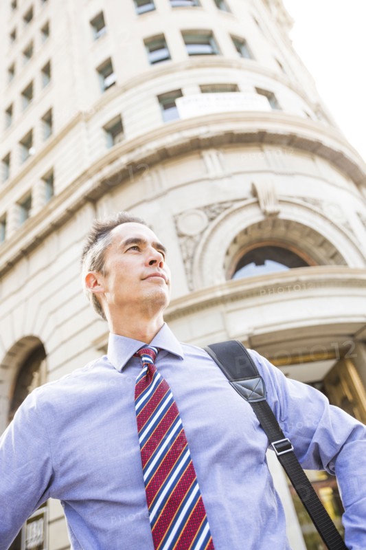 Mixed race businessman standing outdoors