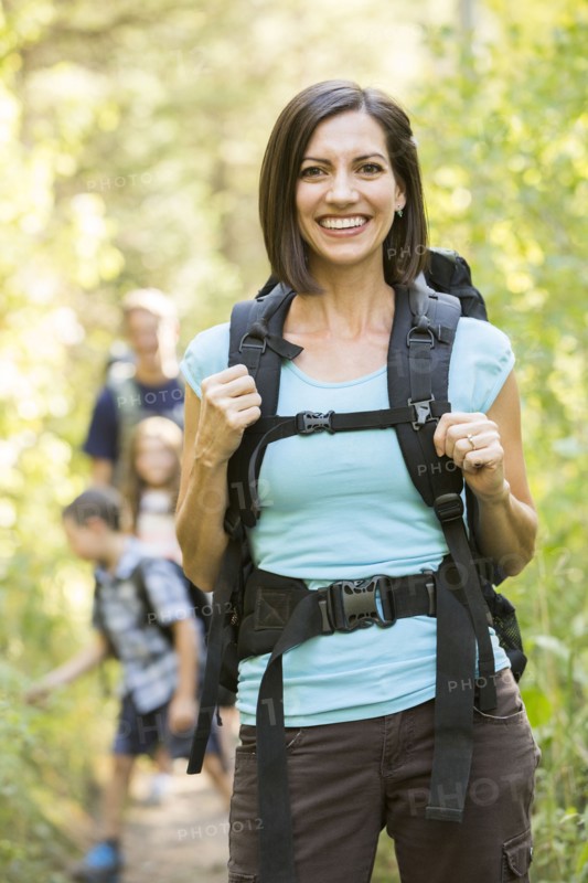 Caucasian family hiking on path