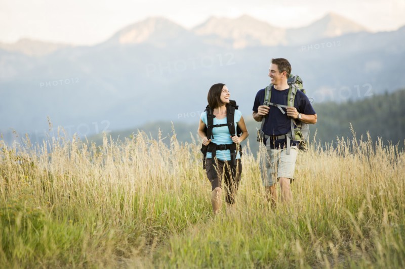 Caucasian couple hiking in remote landscape