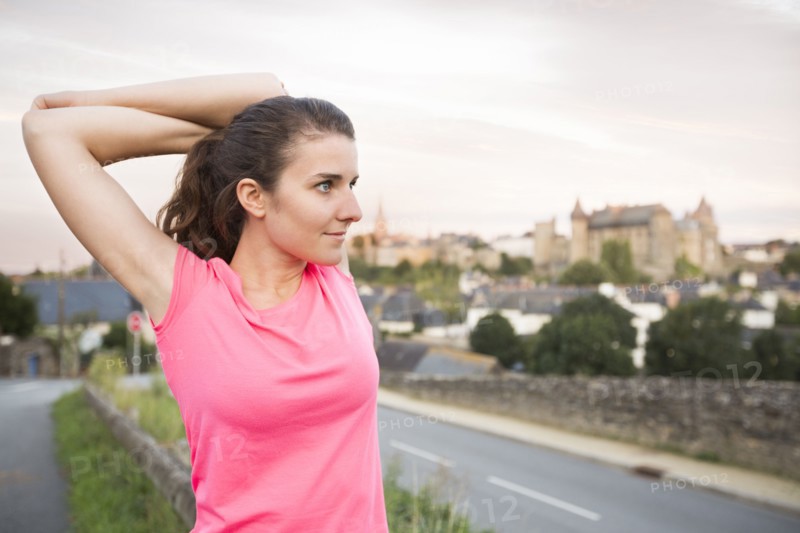 Caucasian woman stretching outdoors