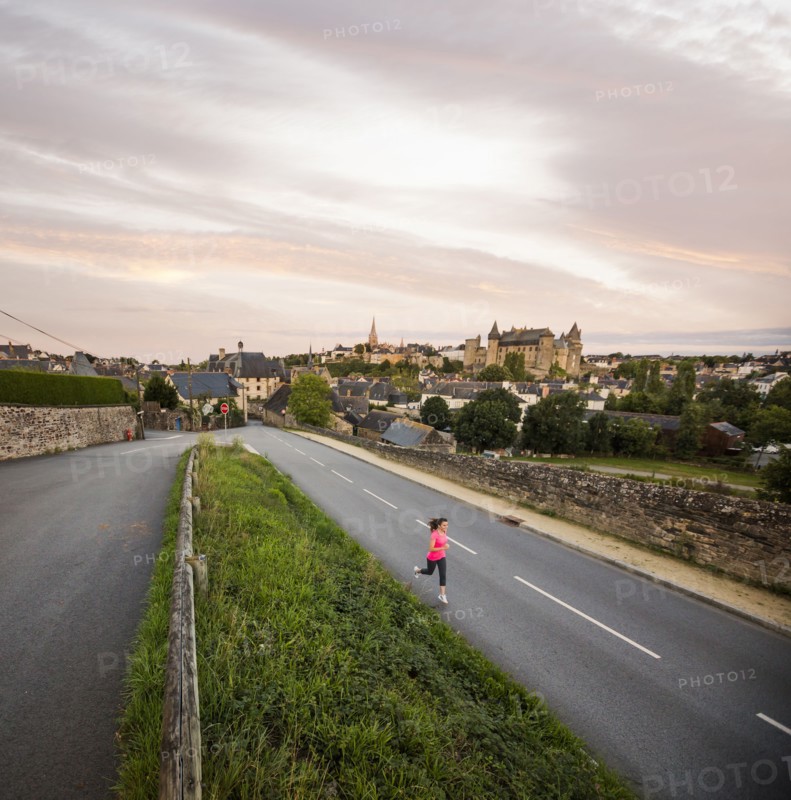 Caucasian woman jogging on road