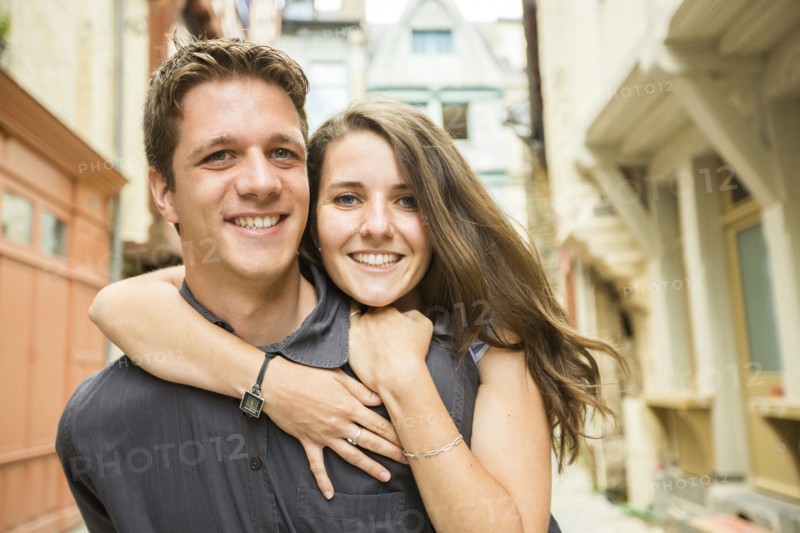 Caucasian couple hugging in village