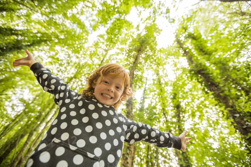 Caucasian girl standing in forest