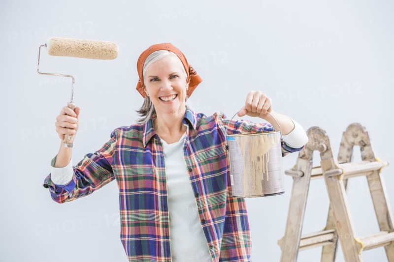 Caucasian woman painting in new home